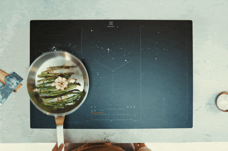 Food in being fried in a pan on an induction hob.