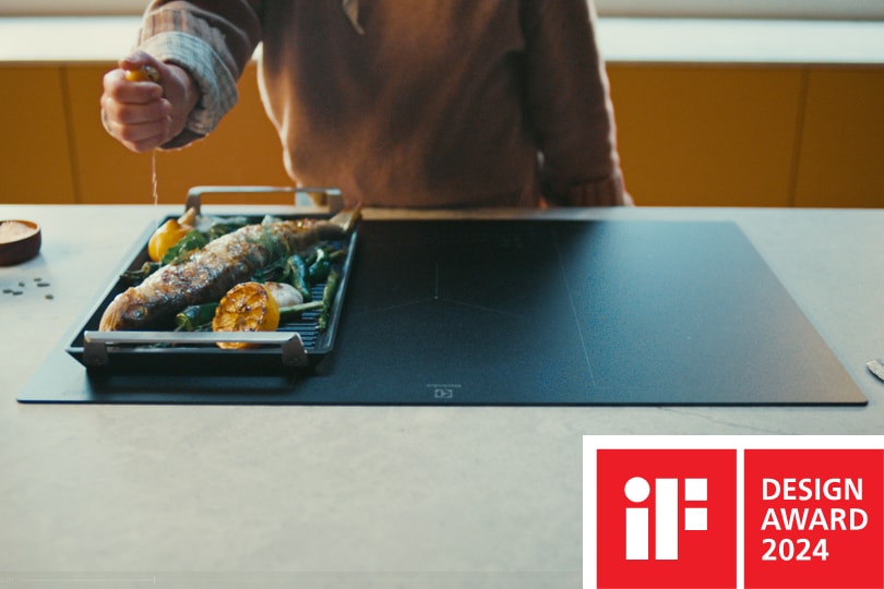 A woman is sprinkling salt over the food.